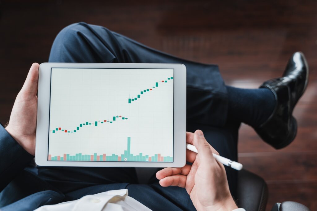 Businessman, investor,trader analyzing,looking at chart of stock prices in tablet. CEO,general manag