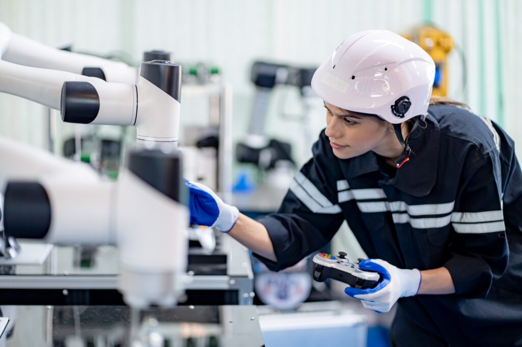 Female engineers working on robotics in industry factory. Technology, people and engineering concept